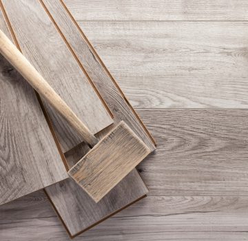 Laminate wood floor and wooden hammer tool. Laminate flooring